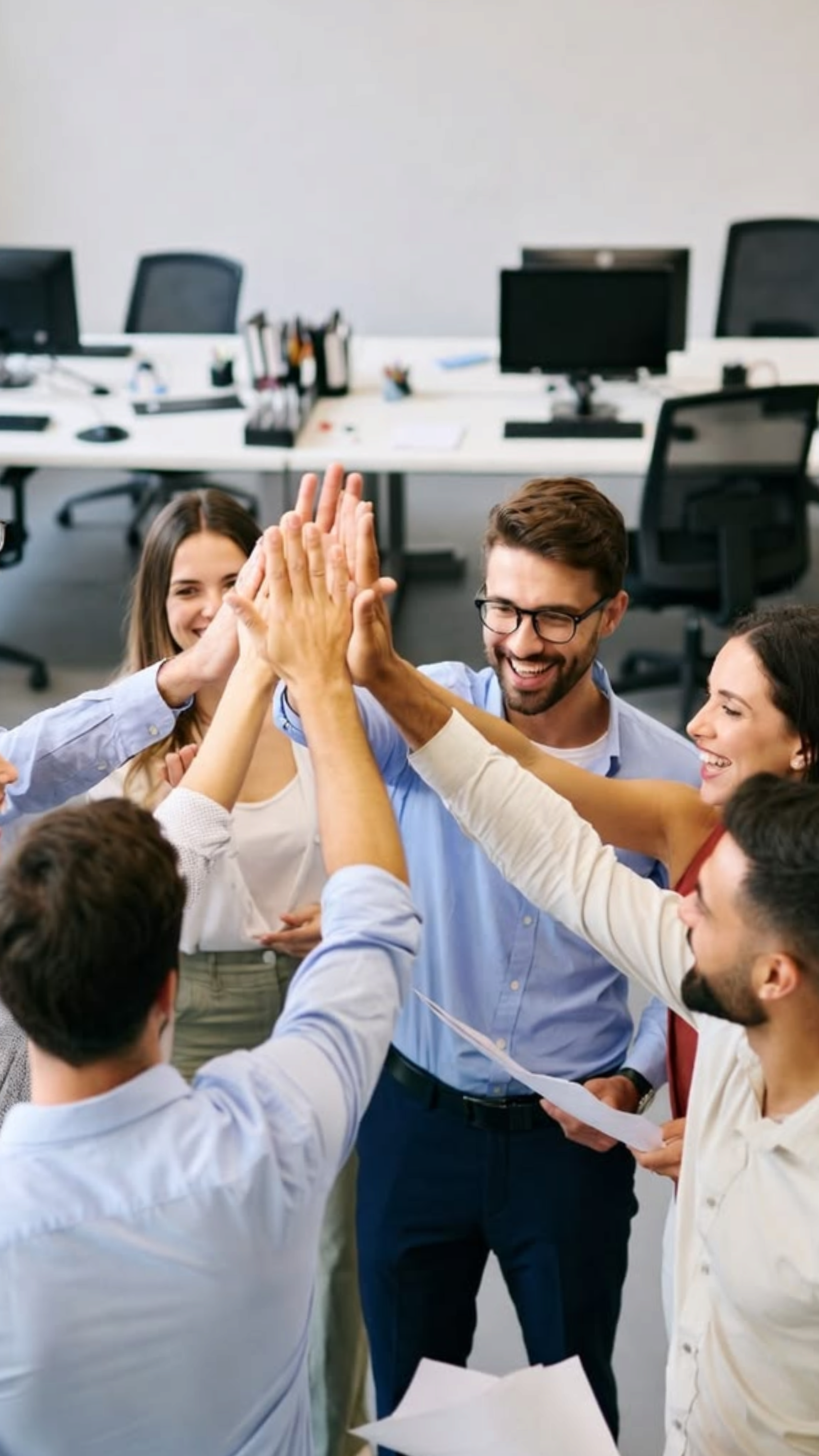 Colleagues sharing a high five in the office