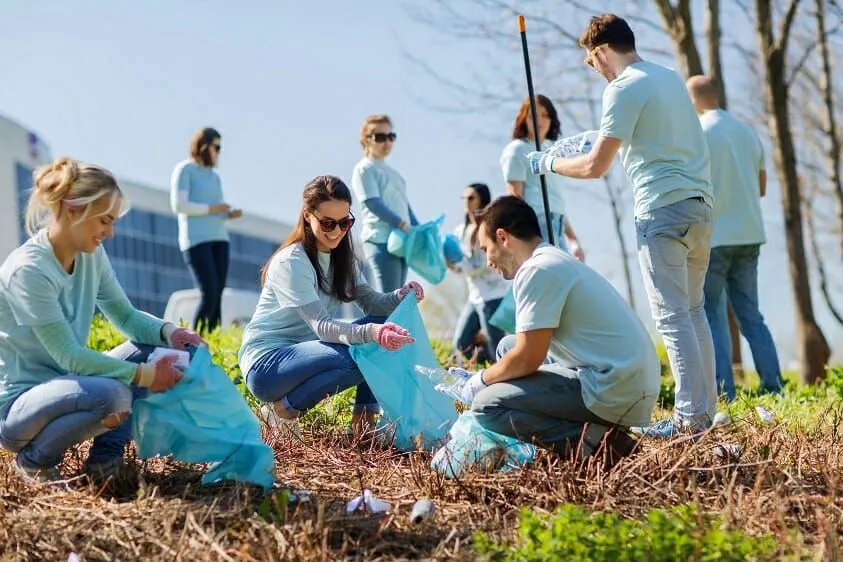 Volunteers collecting litter in a park