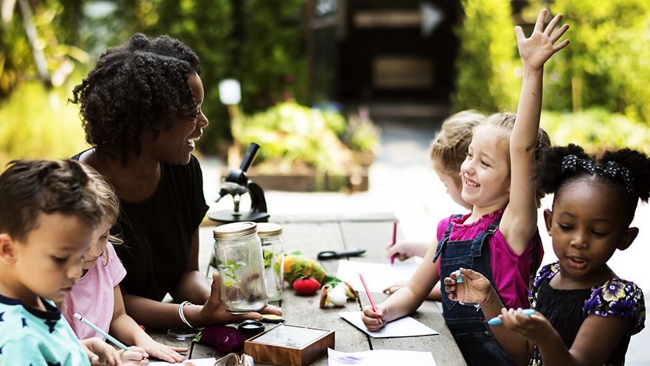 Children learning with a teacher outdoors