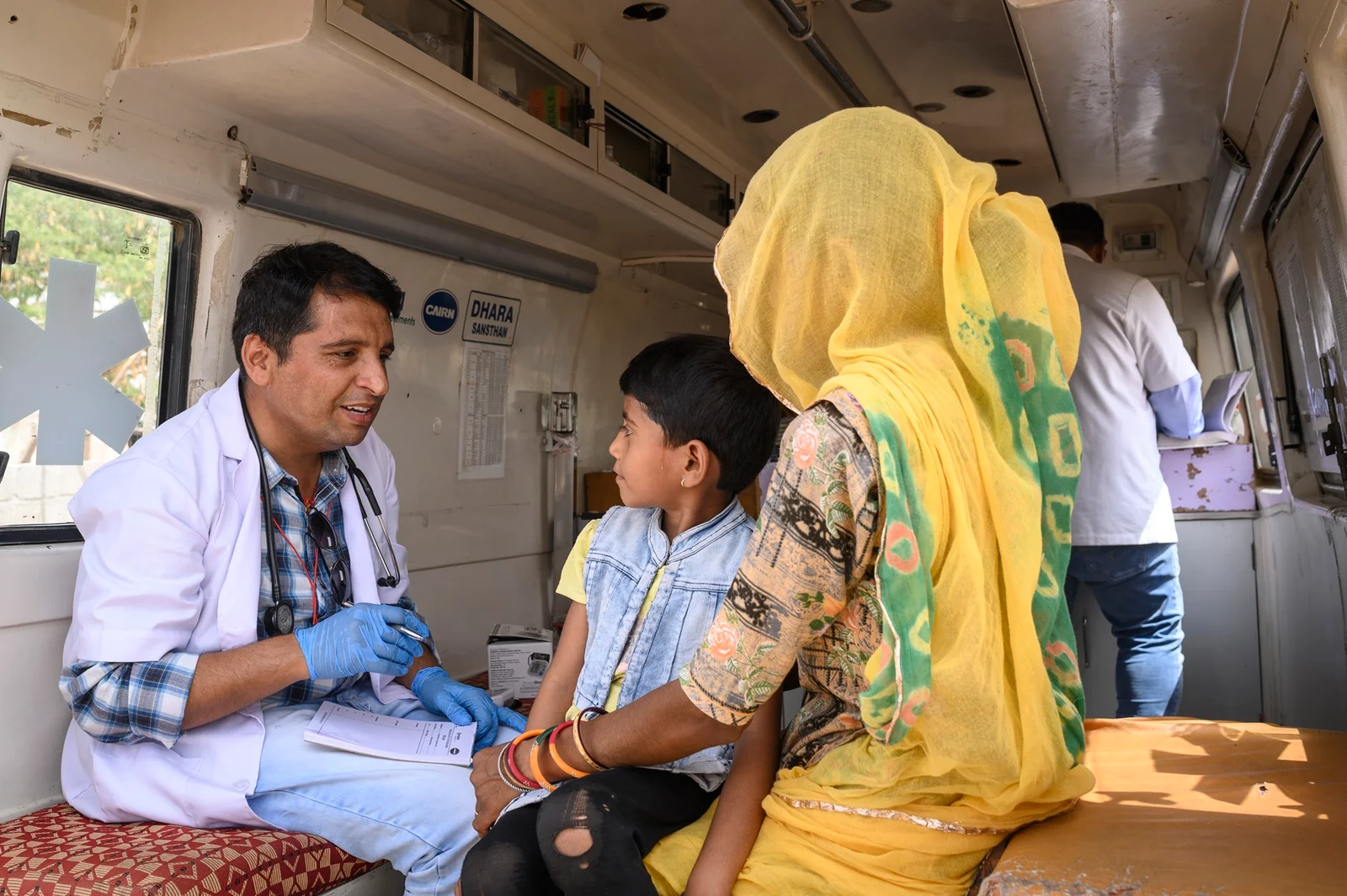 Doctor examining a child in a mobile clinic